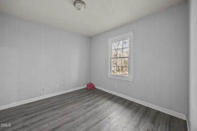 a view of an empty room and wooden floor