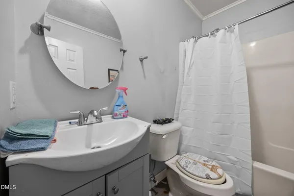 a bedroom with a bed and a potted plant