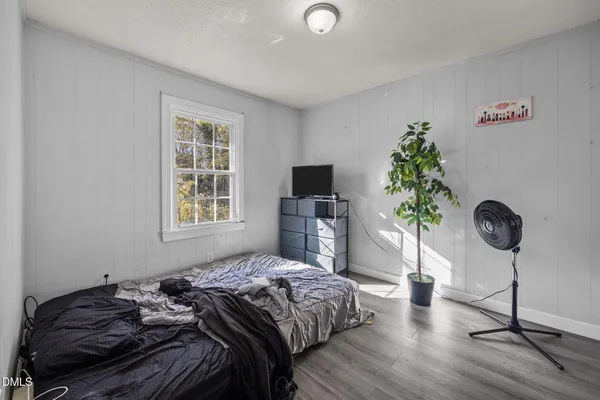 a view of walk in closet with wooden floor