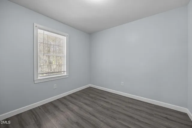 a view of an empty room and wooden floor