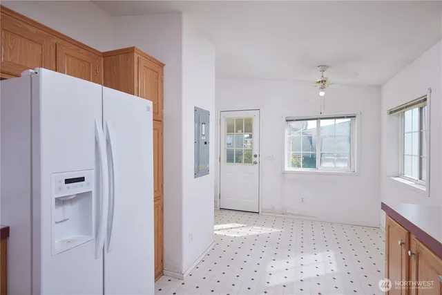 a view of a kitchen with a refrigerator cabinet and a window