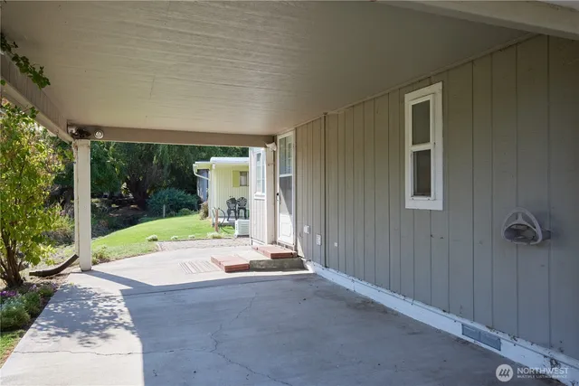 a backyard of a house with table and chairs