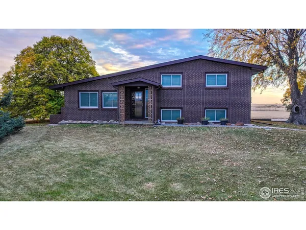 a view of house with backyard