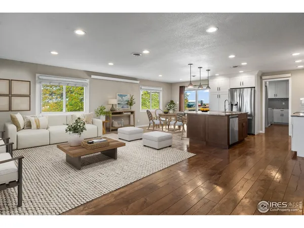 a living room with furniture kitchen and a chandelier