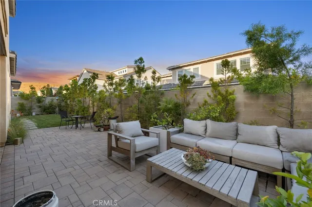 a view of a patio with couches and a table and chairs with wooden floor