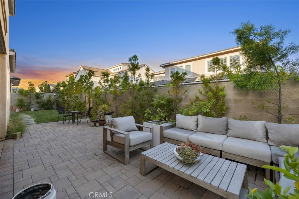 70 Ray Irvine, CA 92618 - Photo 11 of 41 a view of a patio with couches and a table and chairs with wooden floor