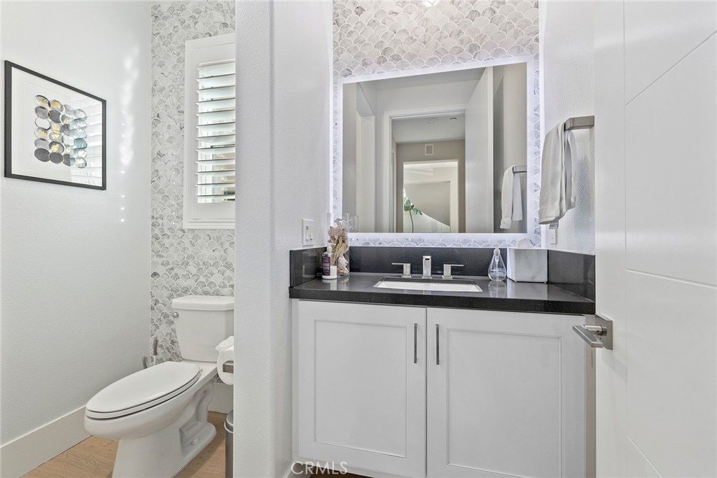 70 Ray Irvine, CA 92618 - Photo 20 of 41 a bathroom with a granite countertop toilet sink and mirror