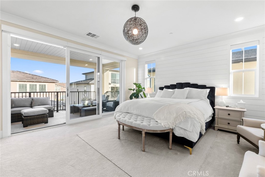 70 Ray Irvine, CA 92618 - Photo 22 of 41 a bedroom with a bed a chandelier and a large window