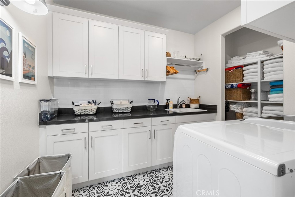 70 Ray Irvine, CA 92618 - Photo 32 of 41 a kitchen with granite countertop white cabinets and sink
