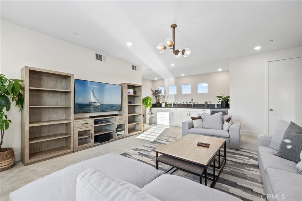 70 Ray Irvine, CA 92618 - Photo 34 of 41 a living room with furniture a flat screen tv and kitchen view