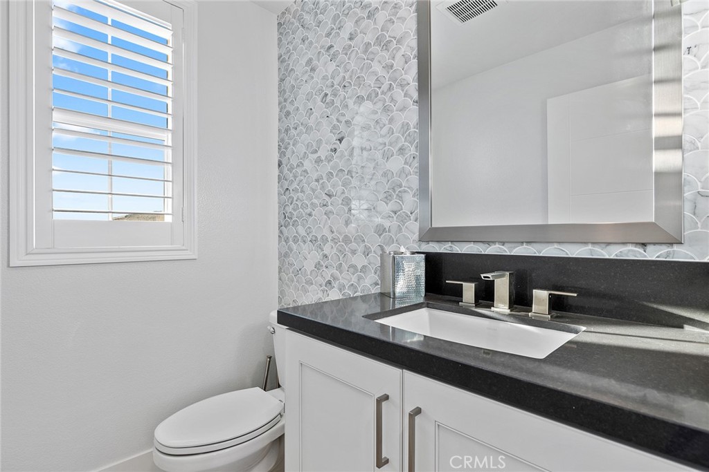 70 Ray Irvine, CA 92618 - Photo 35 of 41 a bathroom with a granite countertop sink toilet and mirror