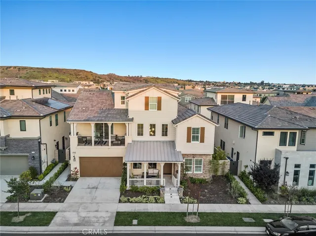 an aerial view of residential houses with outdoor space and trees