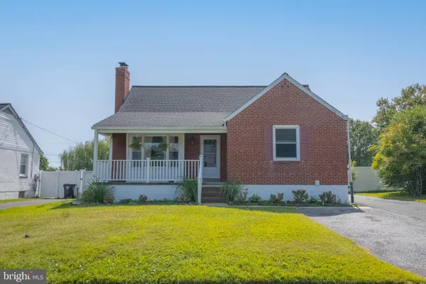 a front view of house with yard and outdoor seating