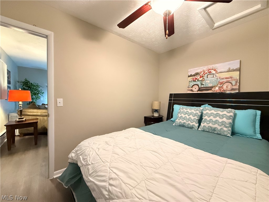 4772 Highway 45 Rome, OH 44085 - Photo 15 of 38 Bedroom featuring neutral wall paint, wood-finish flooring, and a ceiling fan with integrated lighting