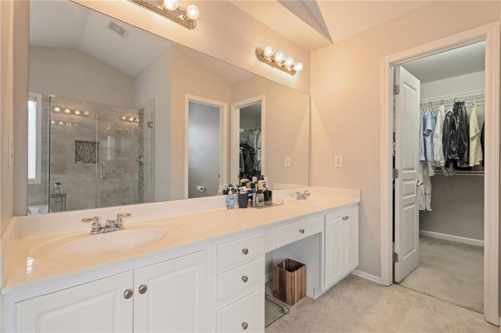 878 Scales Road Suwanee, GA 30024 - Photo 13 of 17 a bathroom with a double vanity sink mirror and shower