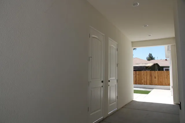 a bathroom with a granite countertop toilet a sink and a mirror