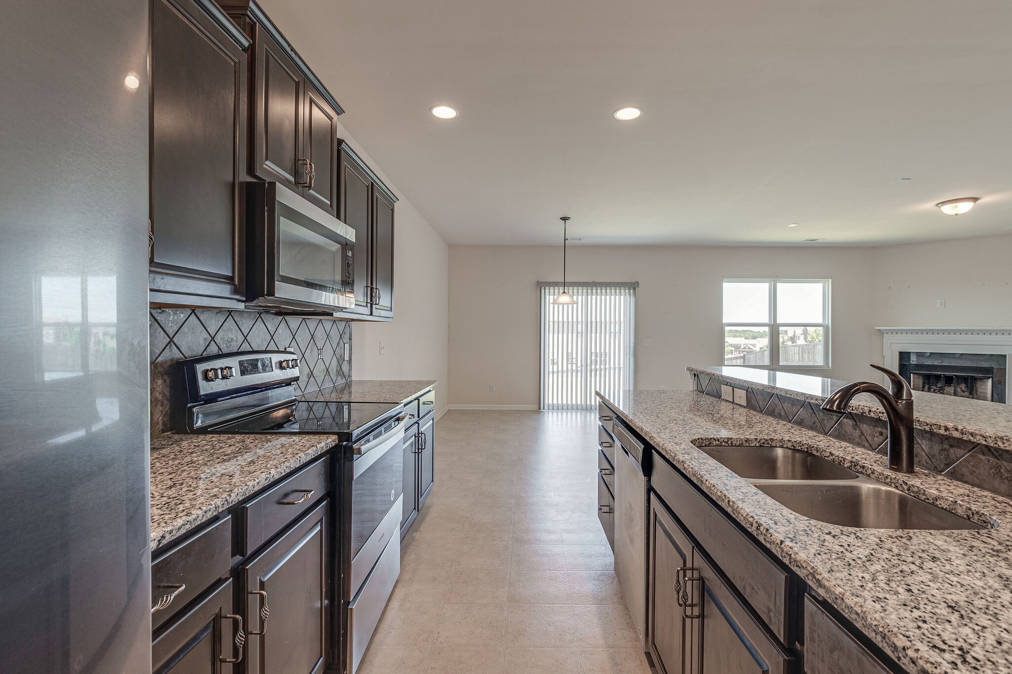 1439 Old Stone Road Lebanon, TN 37087 - Photo 12 of 39 a kitchen with granite countertop stainless steel appliances a sink stove and cabinets