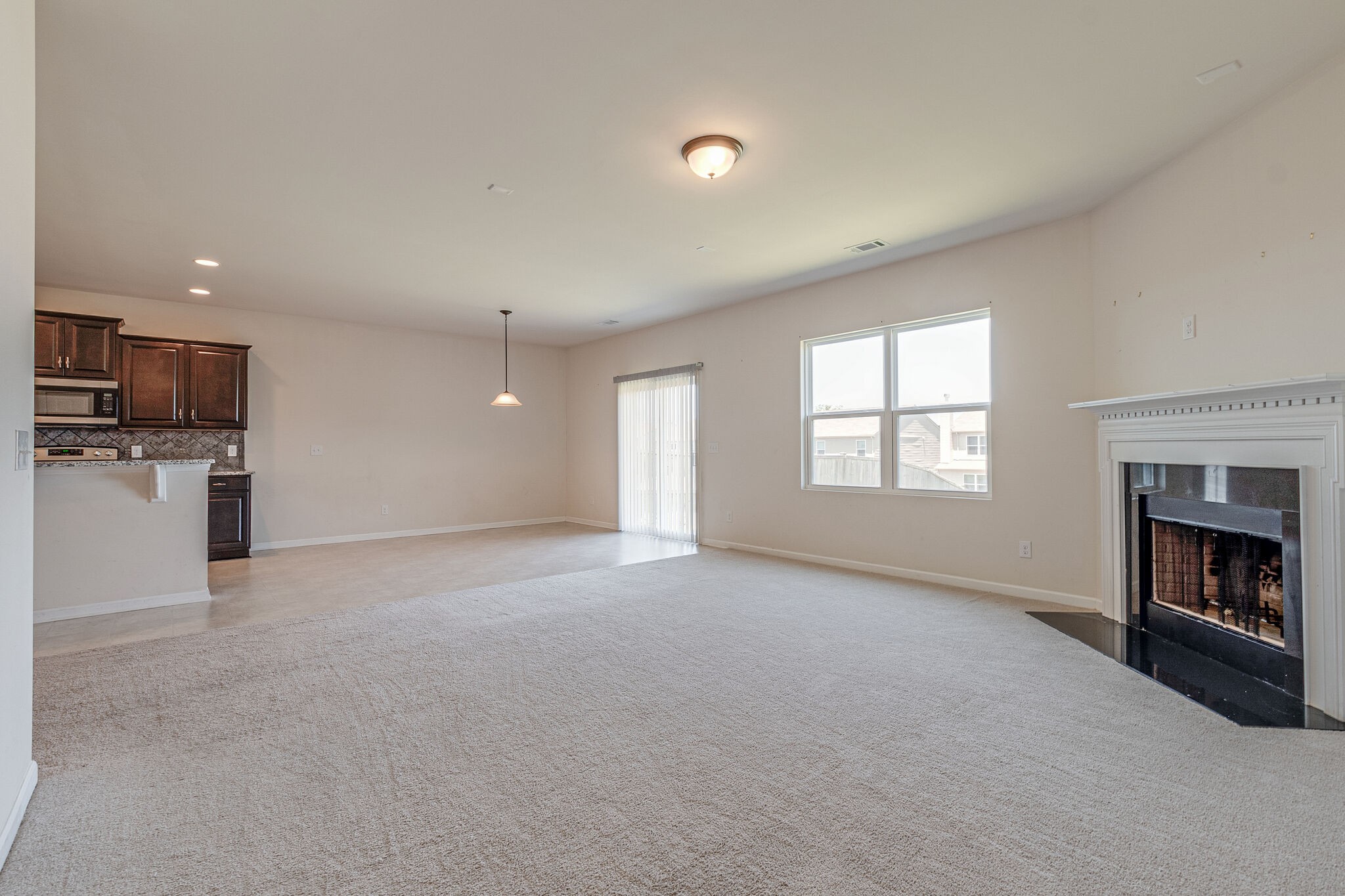 1439 Old Stone Road Lebanon, TN 37087 - Photo 16 of 39 a view of empty room with a kitchen and fireplace
