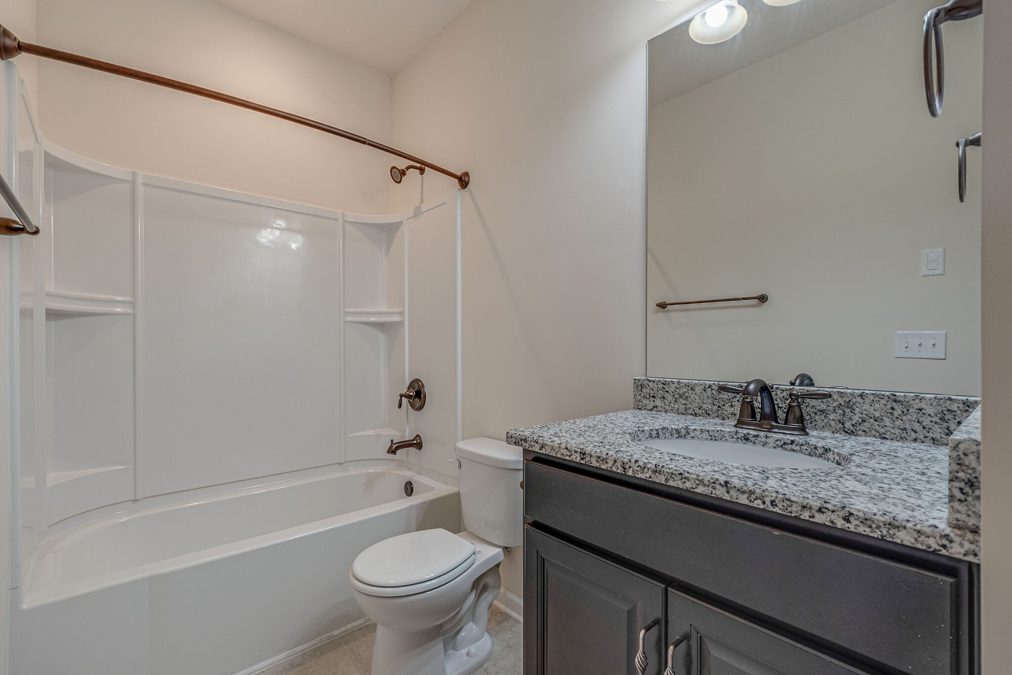 1439 Old Stone Road Lebanon, TN 37087 - Photo 18 of 39 a bathroom with a granite countertop sink a toilet and shower