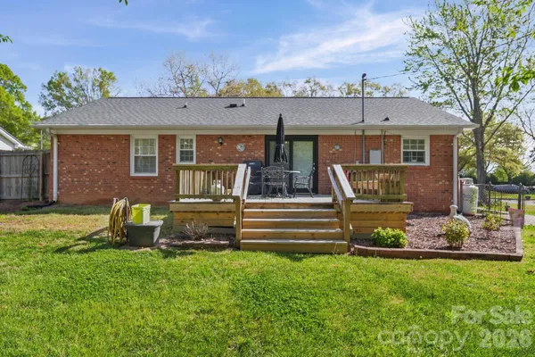 a front view of a house with garden and sitting area