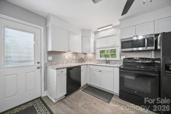a kitchen with granite countertop cabinets stainless steel appliances and a counter space
