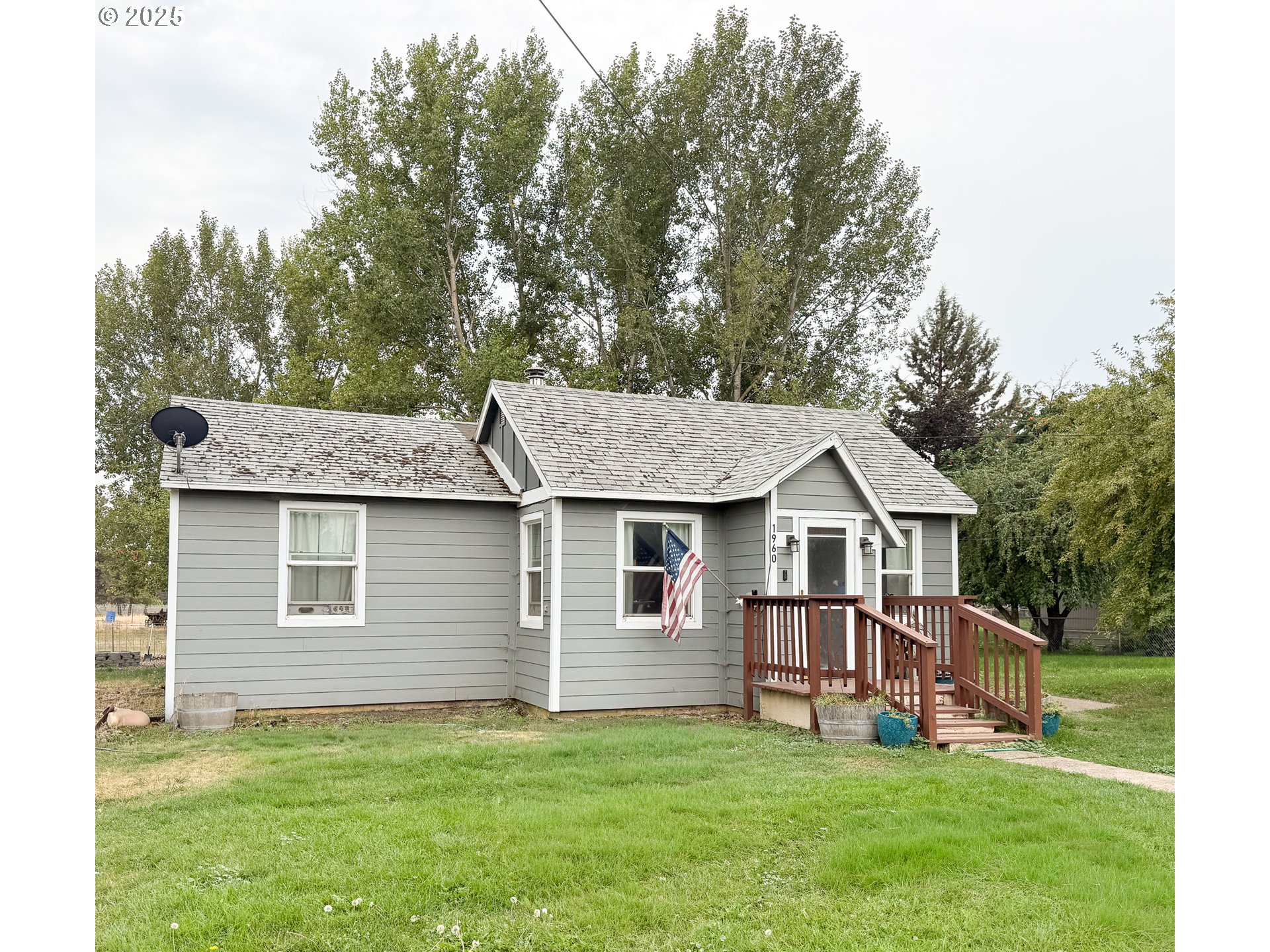 a view of a house with a yard and deck