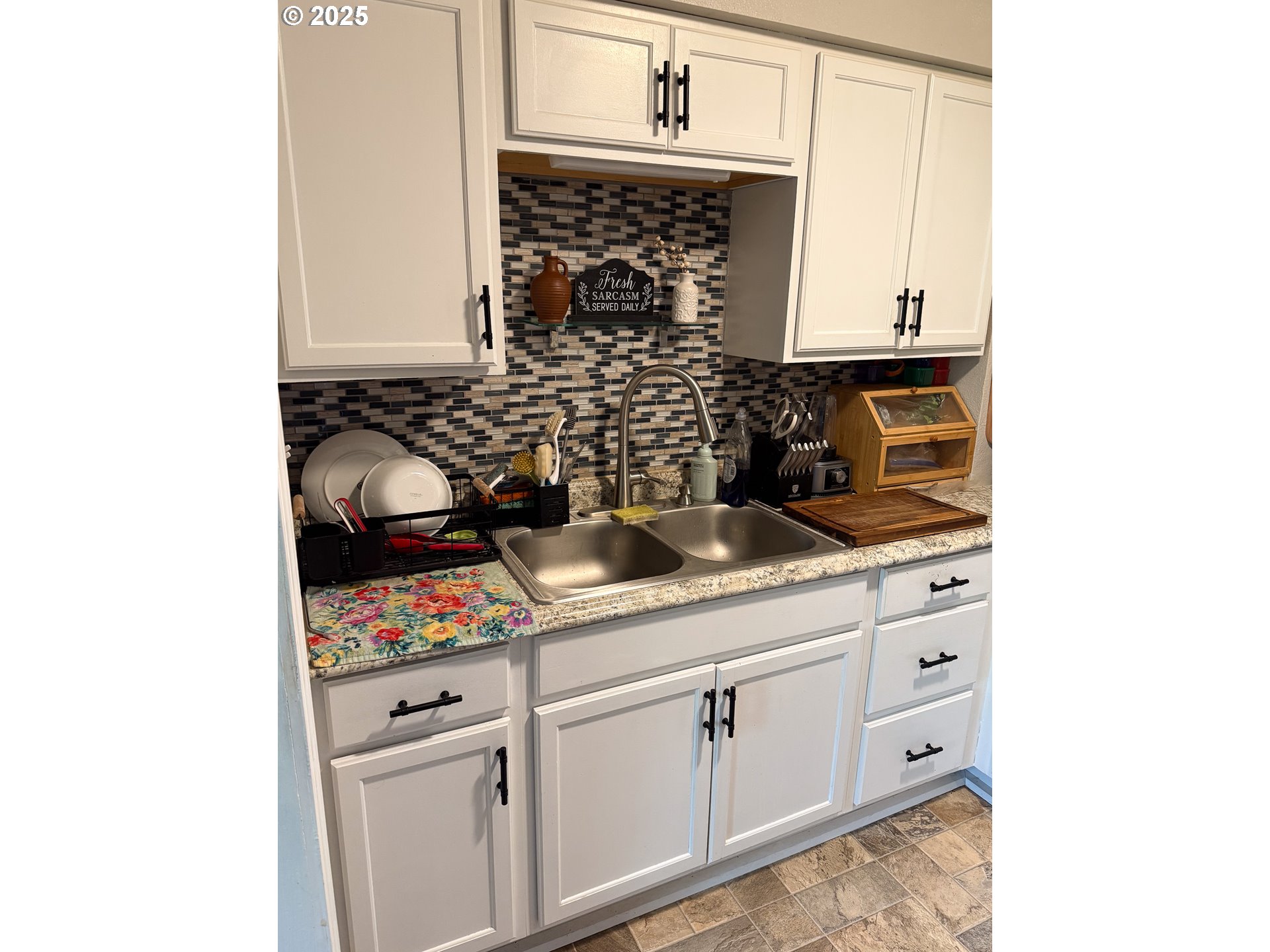 1960 Birch Street Elgin, OR 97827 - Photo 5 of 19 a kitchen with white cabinets and appliances