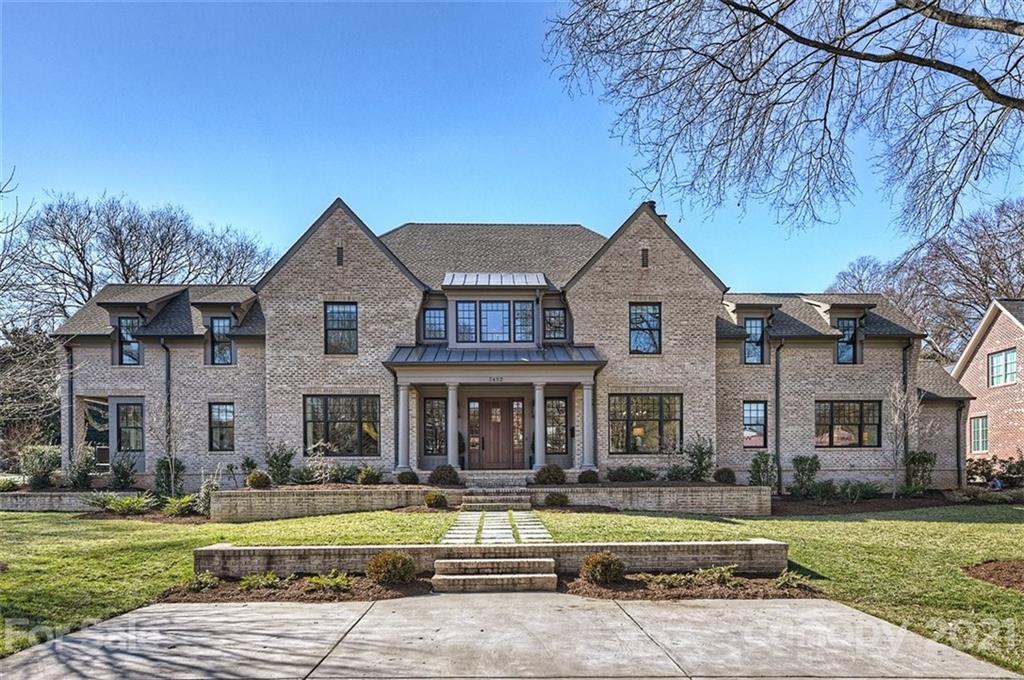 3452 Foxcroft Road Charlotte, NC 28211 - Photo 2 of 48 a front view of a house with a garden and trees