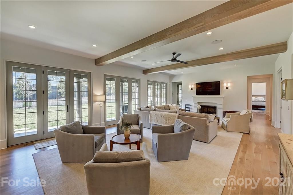 3452 Foxcroft Road Charlotte, NC 28211 - Photo 16 of 48 a living room with furniture a flat screen tv and large windows