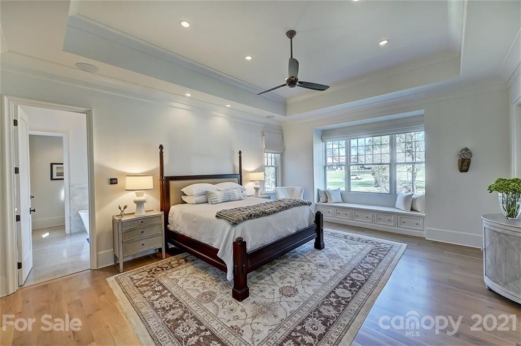 3452 Foxcroft Road Charlotte, NC 28211 - Photo 24 of 48 a spacious bedroom with a bed and a window