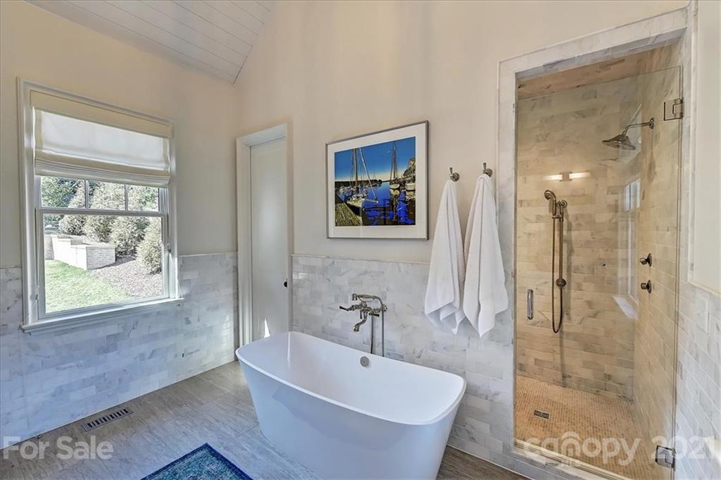 3452 Foxcroft Road Charlotte, NC 28211 - Photo 26 of 48 a bathroom with a bathtub and a shower