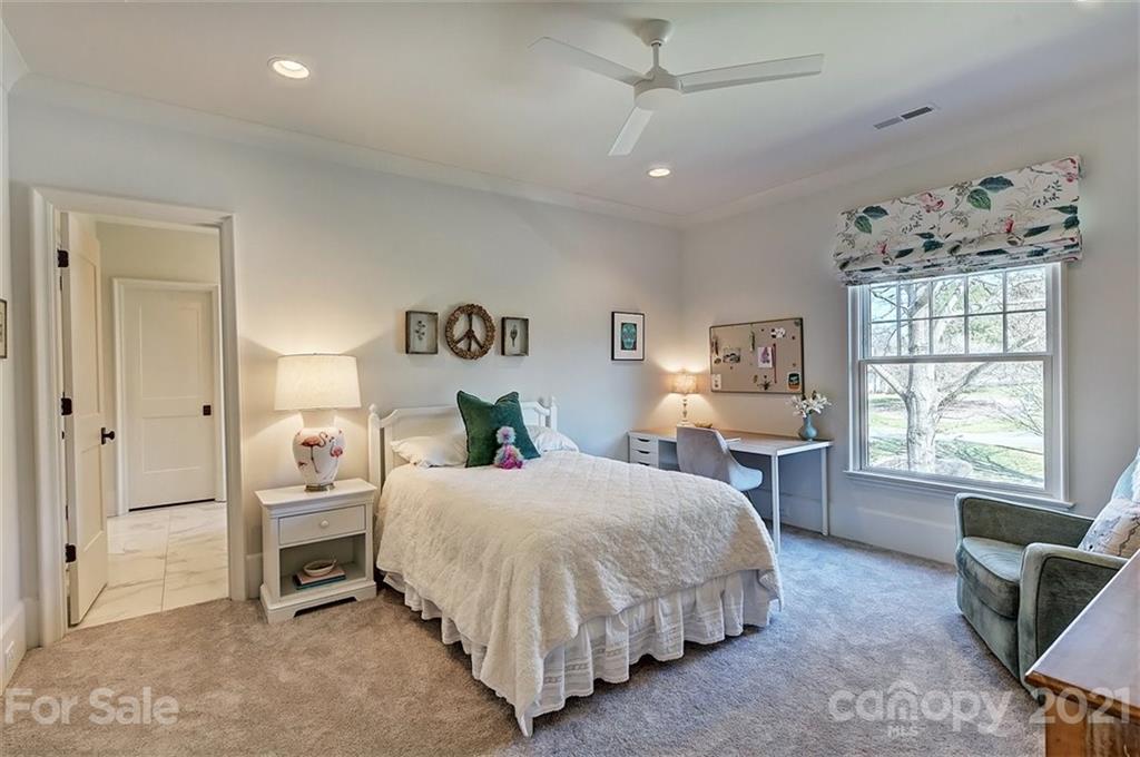 3452 Foxcroft Road Charlotte, NC 28211 - Photo 29 of 48 a bedroom with a bed and a table in it