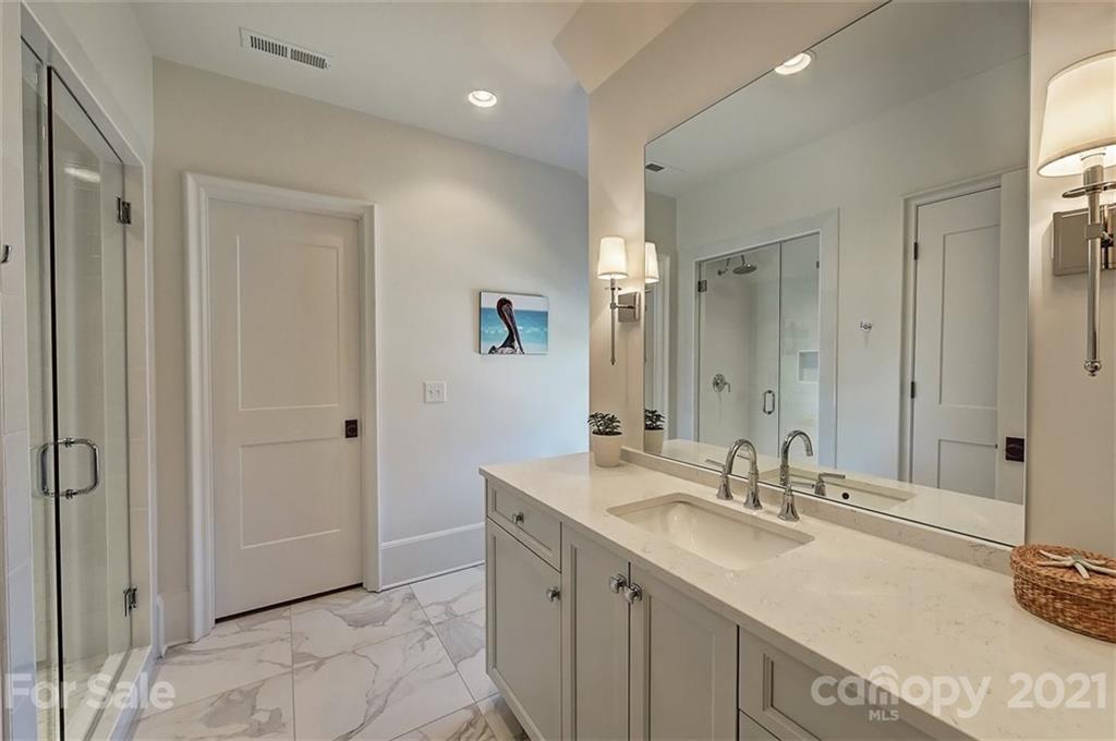 3452 Foxcroft Road Charlotte, NC 28211 - Photo 30 of 48 a bathroom with a sink double vanity and a mirror
