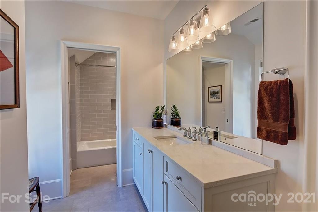 3452 Foxcroft Road Charlotte, NC 28211 - Photo 32 of 48 a bathroom with a sink vanity and a mirror