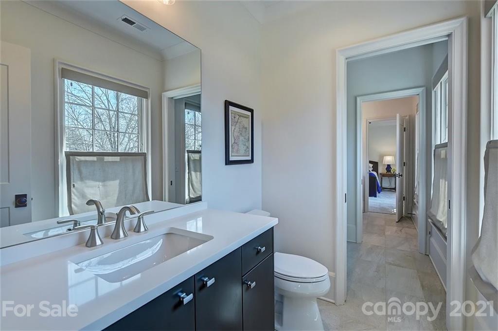 3452 Foxcroft Road Charlotte, NC 28211 - Photo 33 of 48 a bathroom with a granite countertop sink toilet and mirror