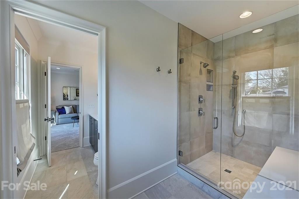 3452 Foxcroft Road Charlotte, NC 28211 - Photo 35 of 48 a bathroom with a glass shower door