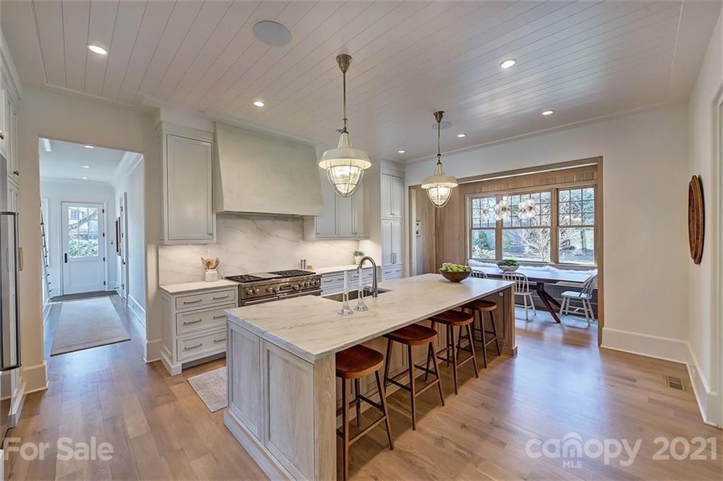 3452 Foxcroft Road Charlotte, NC 28211 - Photo 7 of 48 a kitchen with a stove a sink and a refrigerator