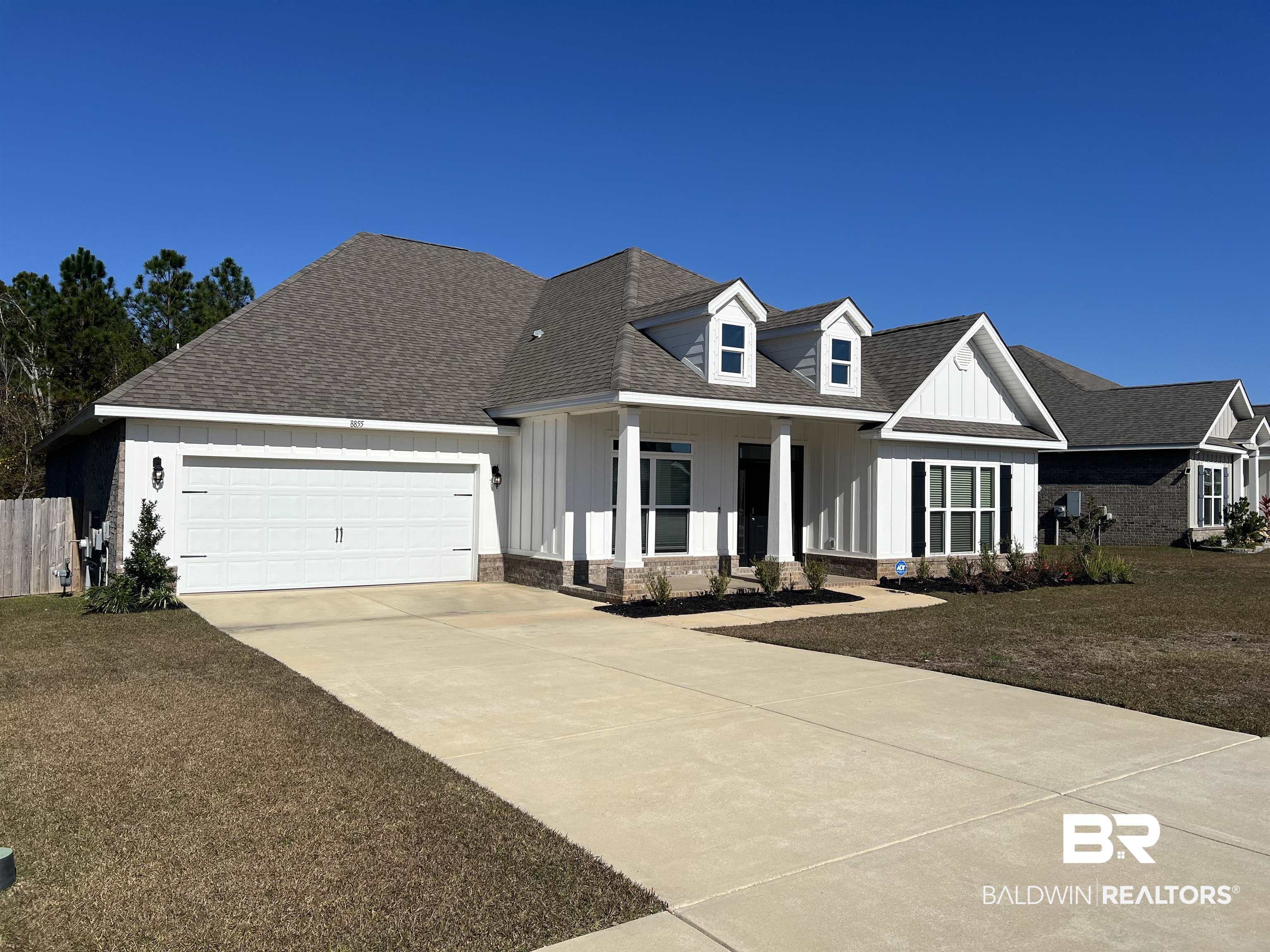 8855 Calverton Street Foley, AL 36535 - Photo 4 of 76 View of front facade featuring a garage and a front lawn
