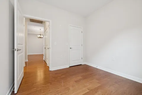 a view of hallway with wooden floor
