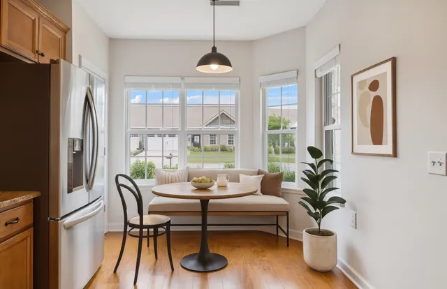 a dining room with furniture a chandelier and wooden floor