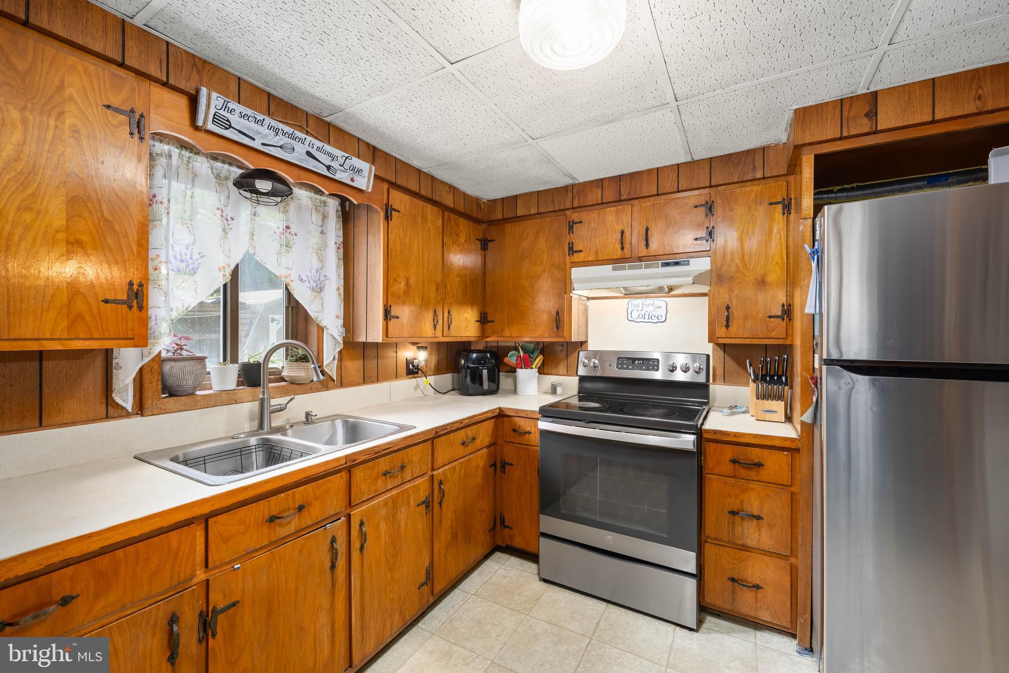 26467 Mariners Road Crisfield, MD 21817 - Photo 22 of 44 a kitchen with stainless steel appliances a sink cabinets and a window