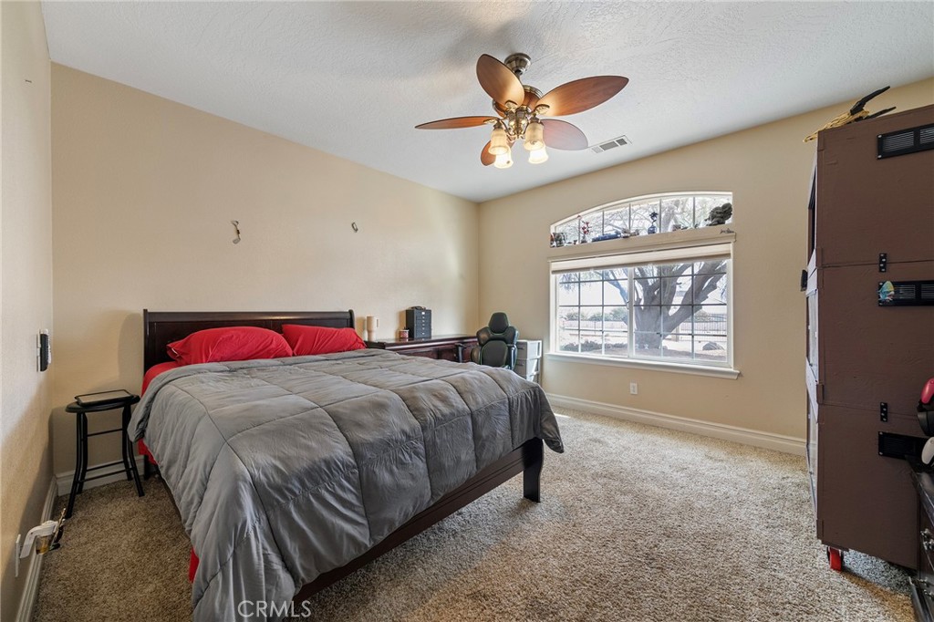 7172 Jargon Road Hesperia, CA 92344 - Photo 31 of 75 a bed sitting in a bedroom next to a window
