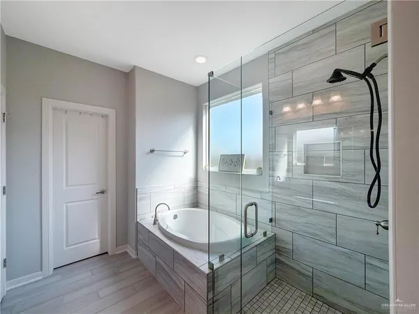 a bathroom with a tub and shower
