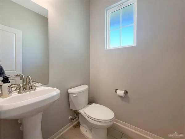 a bathroom with a sink mirror and toilet