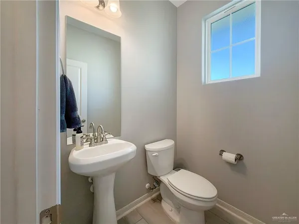 a bathroom with a sink toilet and mirror
