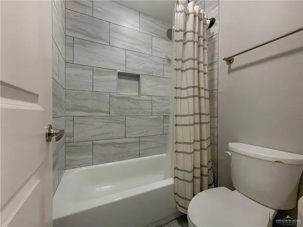 a bathroom with a toilet and shower