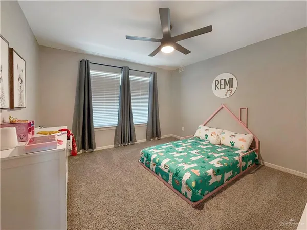 a bedroom with bed and a chandelier