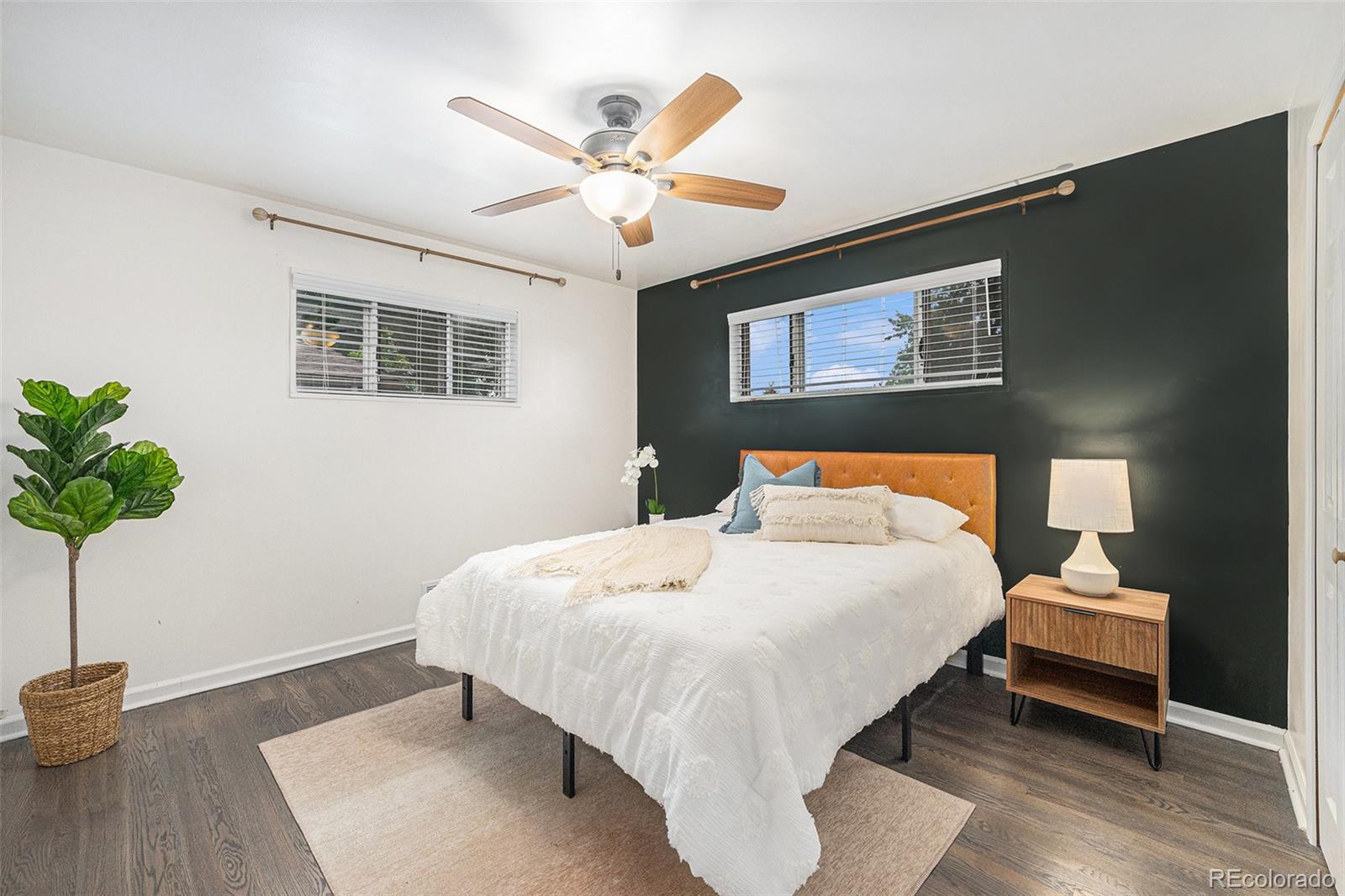 7625 Turner Drive Denver, CO 80221 - Photo 13 of 26 a bedroom with a bed and a chandelier