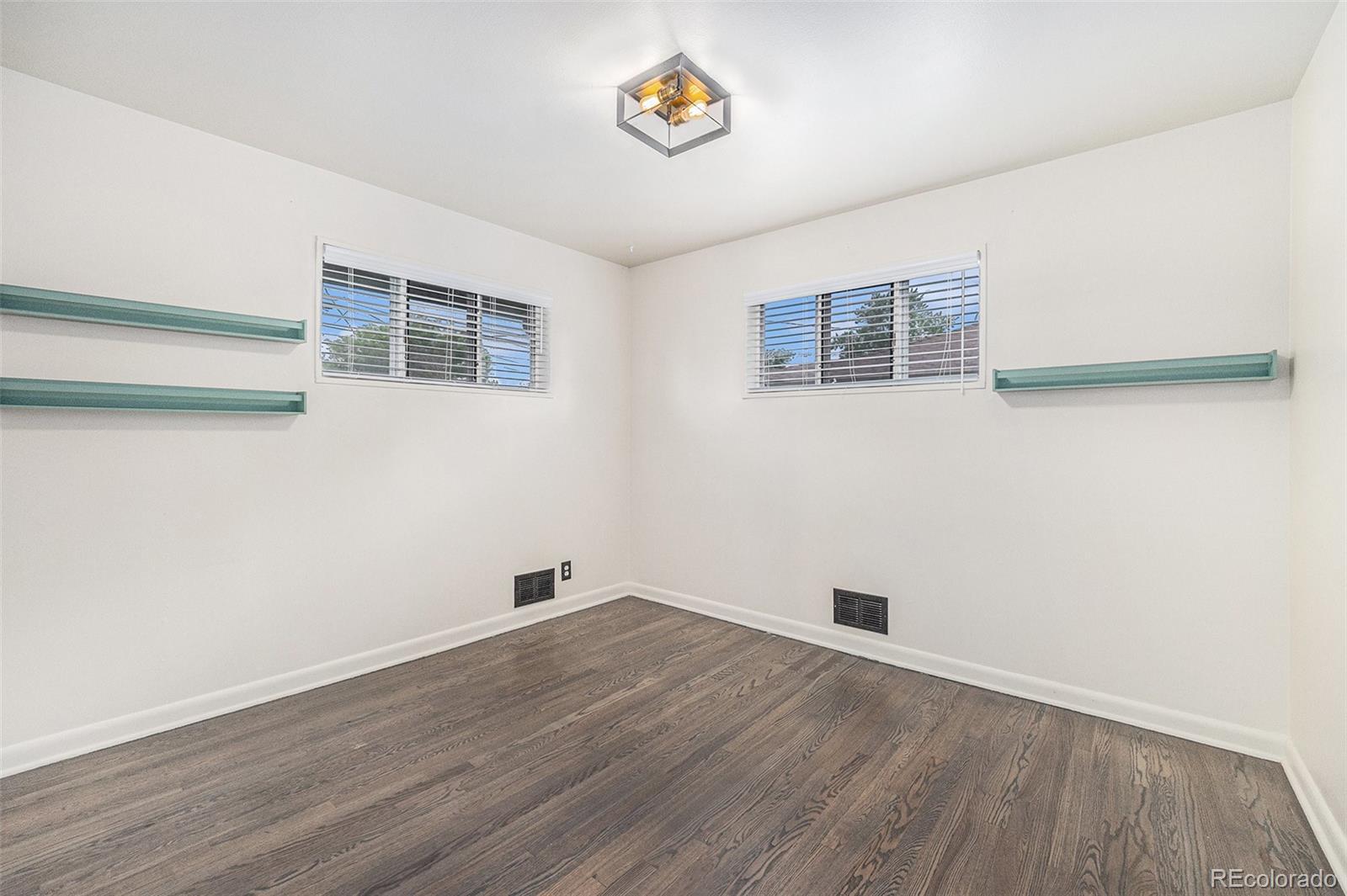 7625 Turner Drive Denver, CO 80221 - Photo 16 of 26 an empty room with wooden floor and windows