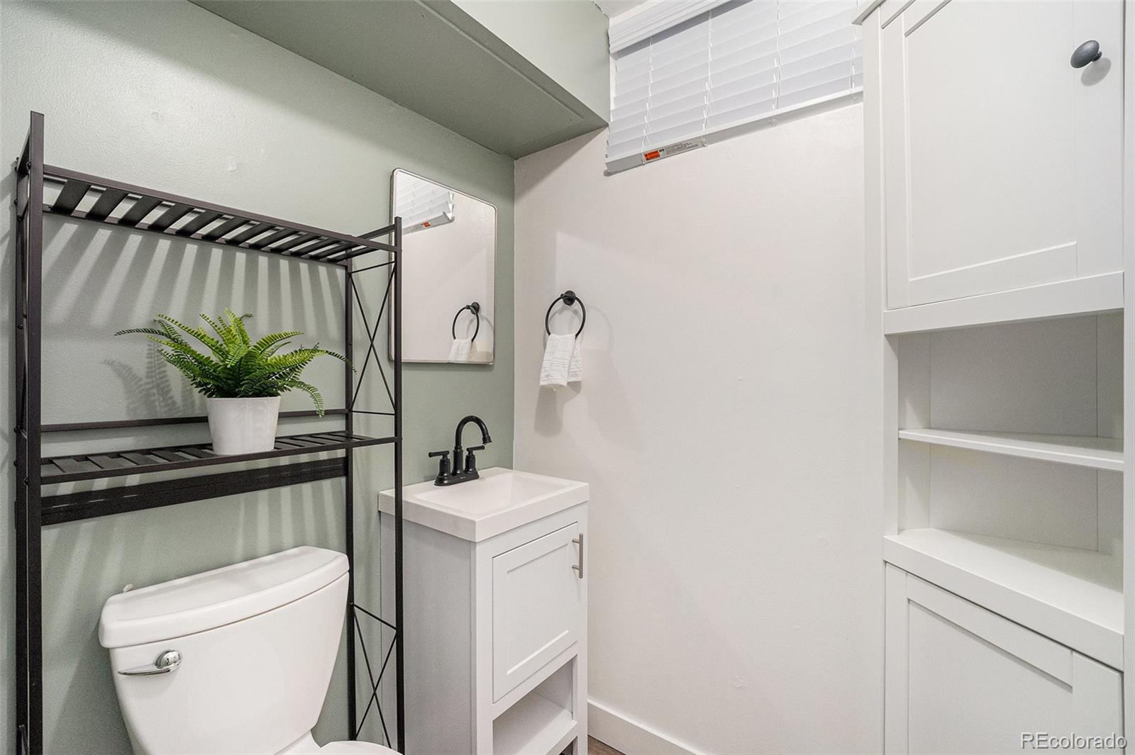 7625 Turner Drive Denver, CO 80221 - Photo 19 of 26 a bathroom with a toilet a sink and a mirror